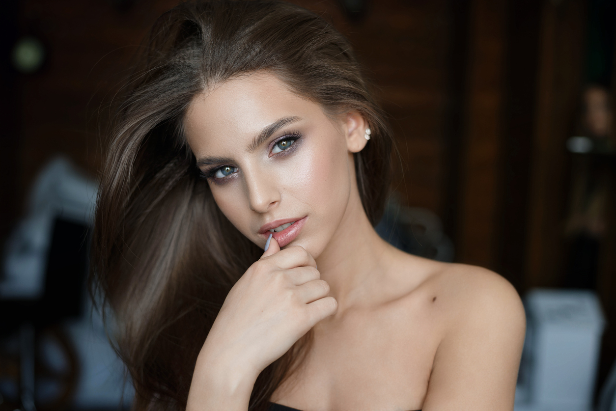 Smiling girl close up portrait. Long hair young model.